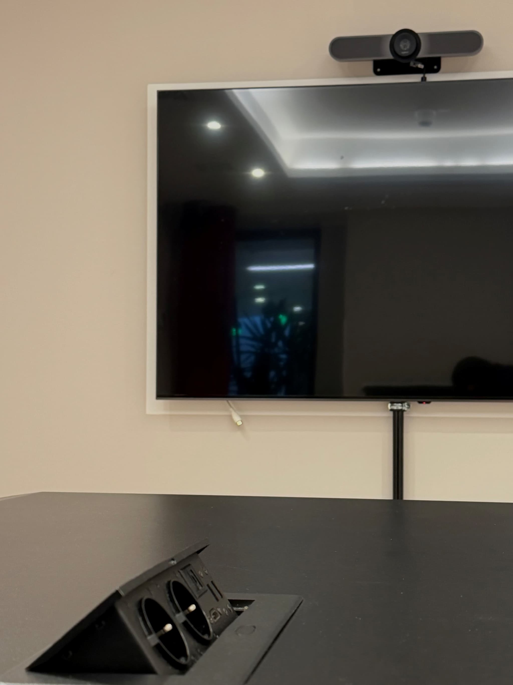 Vibrant 'Pioneer' meeting space with standing table at SPACE SHACK Coworking interior photo 1