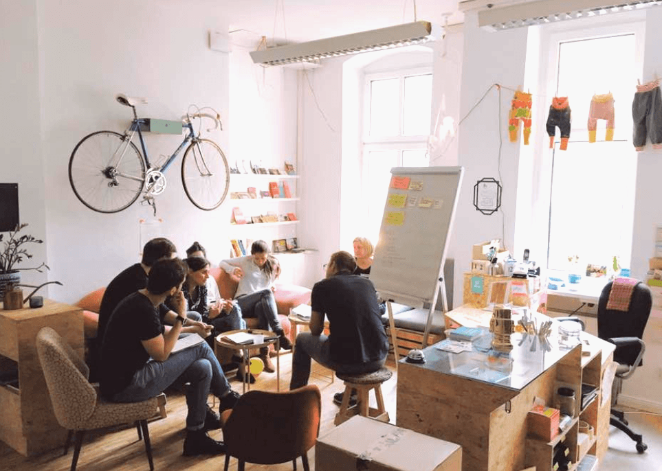 Versatile space equipped with flatscreen & unique chalkboard wall at juggleHUB interior photo 2