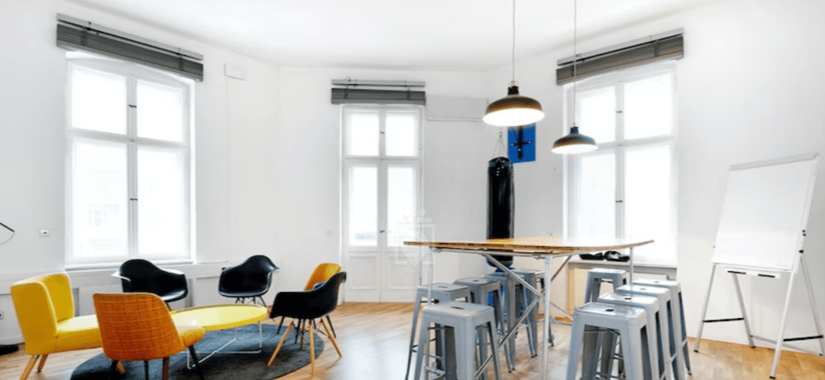 Versatile space equipped with flatscreen & unique chalkboard wall at juggleHUB interior photo 4